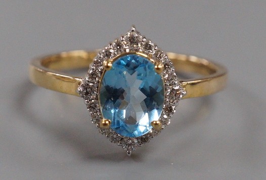 A modern 9k yellow metal, blue topaz and diamond chip set navette shaped cluster ring, size Q, gross weight 3 grams.